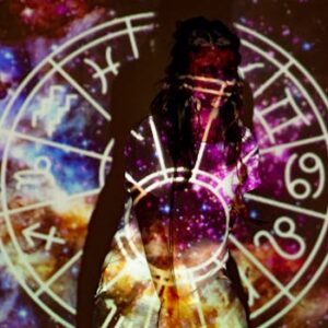 A mystical image of a woman enveloped in celestial projections and astrological symbols.